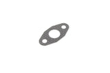 Metal engine gasket with central opening and mounting holes on a white background