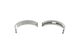 Two semi-circular metal engine main bearing shells for German auto parts.