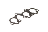 Black multi-port engine exhaust manifold gasket for German auto parts.