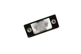 Rectangular clear lens automotive light housing with mounting screws on a black base.