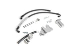 Automotive repair kit including black hoses, silver metal components, and replacement parts.