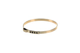 Gold-colored metal hose clamp with a slotted tightening band on a white background