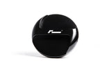 Black spherical automotive gear shift knob with white R logo on a white background