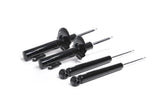 Set of four black automotive shock absorbers for German vehicle suspension maintenance.